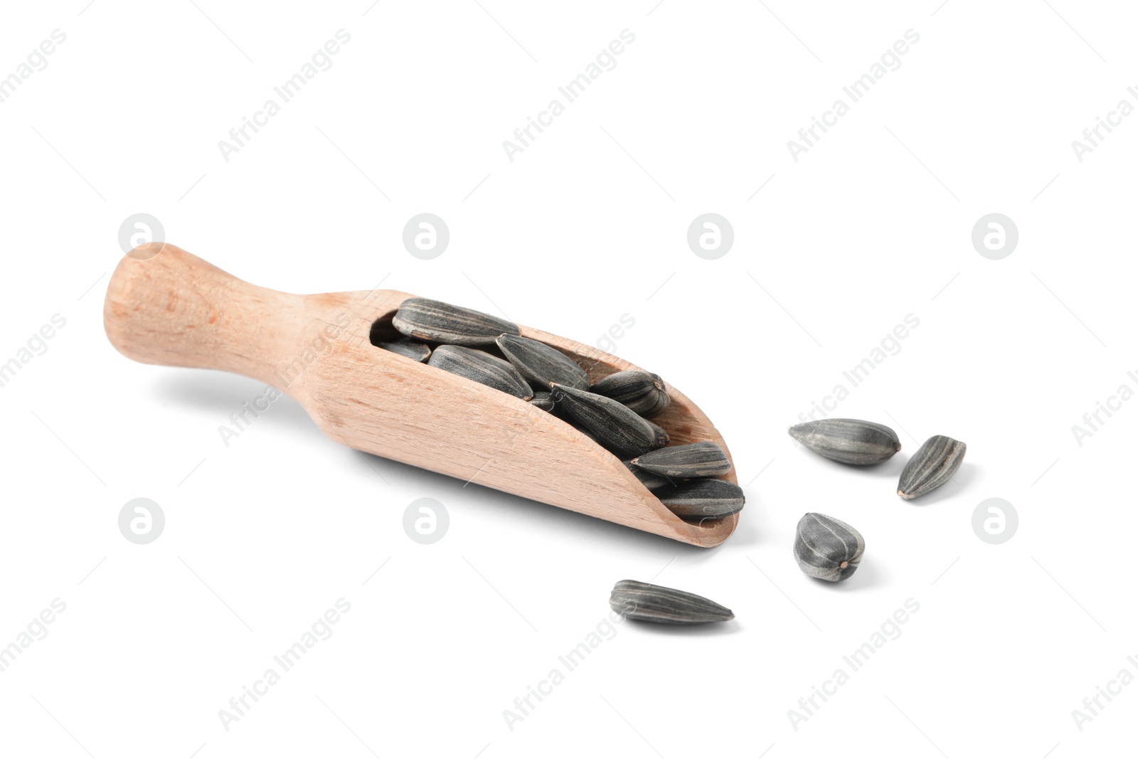 Photo of Raw organic sunflower seeds in wooden scoop isolated on white