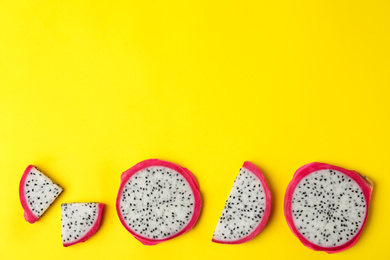 Delicious sliced dragon fruit (pitahaya) on yellow background, flat lay. Space for text