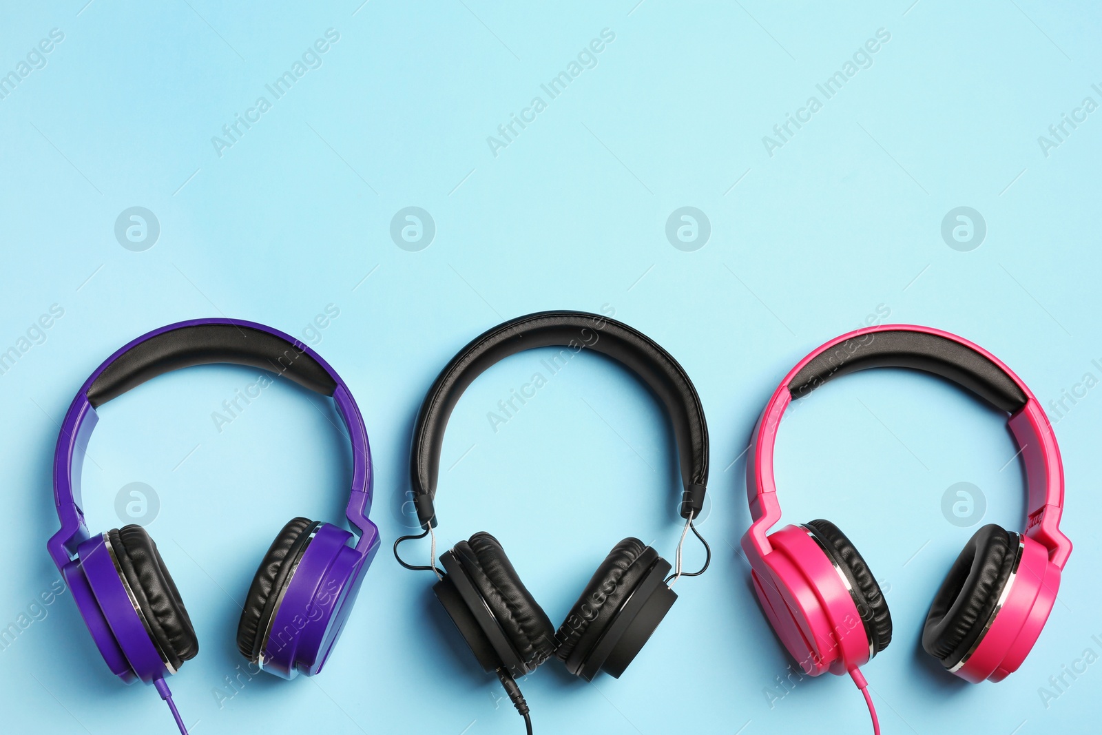 Photo of Stylish headphones on color background, flat lay. Space for text