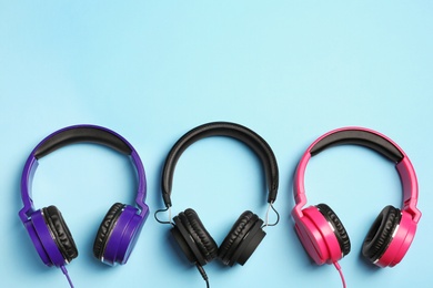 Stylish headphones on color background, flat lay. Space for text