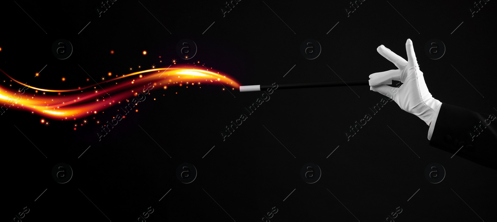 Image of Magician showing trick with wand black background, closeup. Banner design