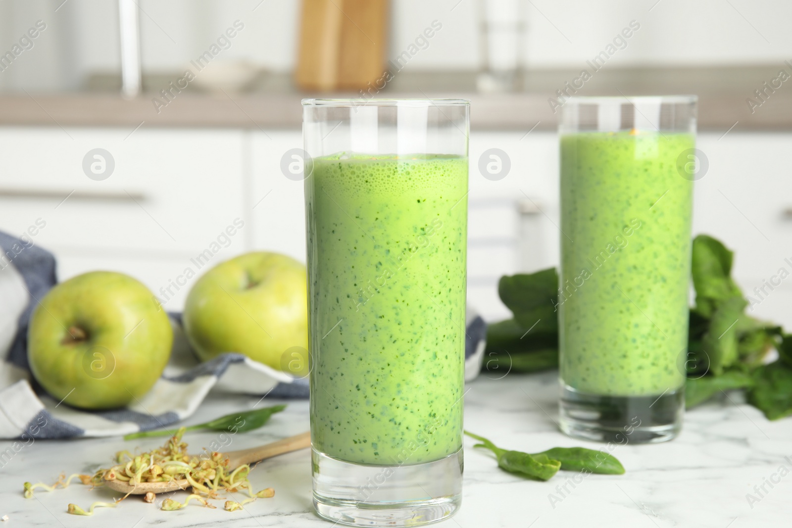 Photo of Green buckwheat smoothie on white marble table