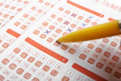 Photo of Filling out lottery ticket with pen, closeup. Space for text