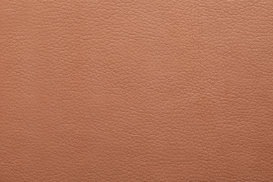 Texture of light brown leather as background, closeup