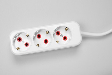 Photo of Power strip on white background, top view