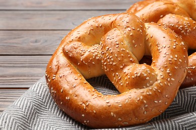 Photo of Tasty freshly baked pretzels on table, closeup view