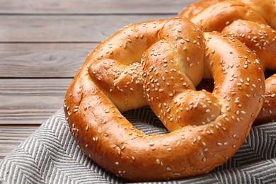 Tasty freshly baked pretzels on table, closeup view