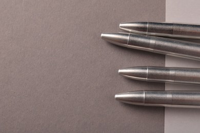 Photo of Many metal bullets on color background, flat lay. Space for text