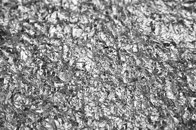 Crumpled silver foil as background, closeup view