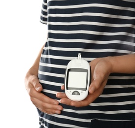 Photo of Pregnant woman holding glucometer on white background. Diabetes test