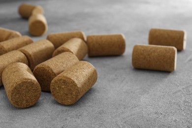 Photo of Wine bottle corks on light grey table, closeup