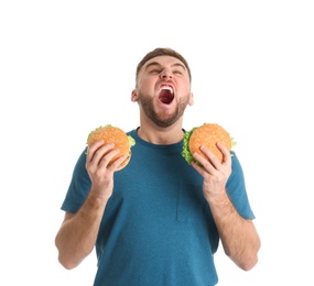 Young man with tasty burgers on white background