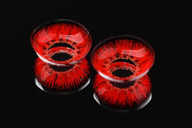 Photo of Two red contact lenses on black background