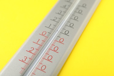 Photo of Modern weather thermometer on yellow background, closeup
