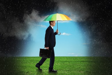 Image of Businessman with umbrella under heavy rain. Insurance concept