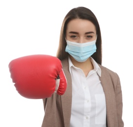 Photo of Businesswoman with protective mask and boxing gloves on white background. Strong immunity concept