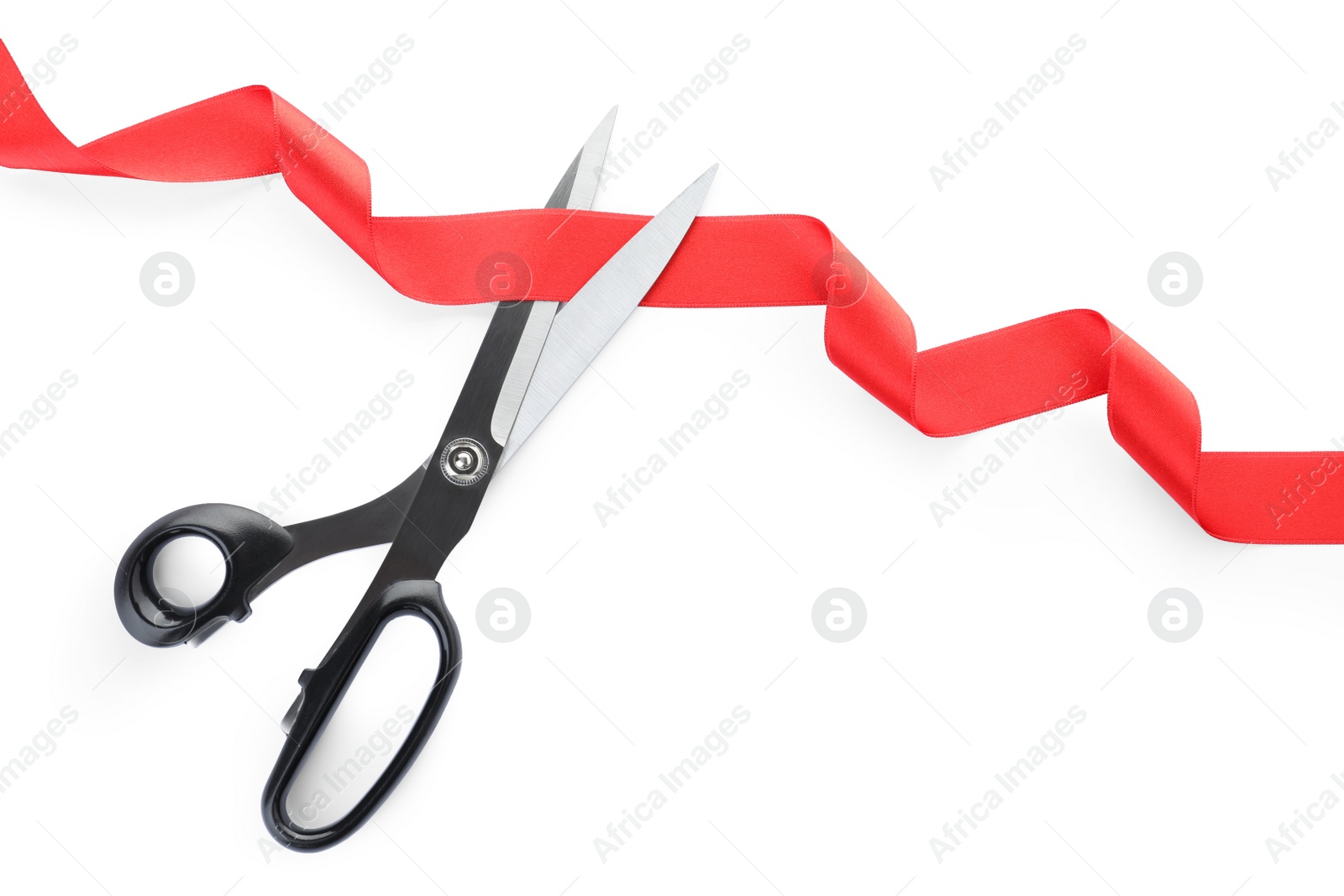 Photo of Stylish scissors and red ribbon on white background. Ceremonial tape cutting