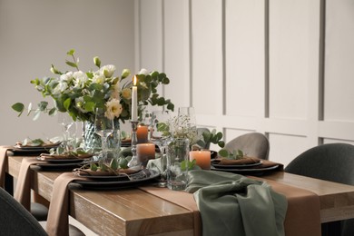 Photo of Festive table setting with beautiful floral decor indoors