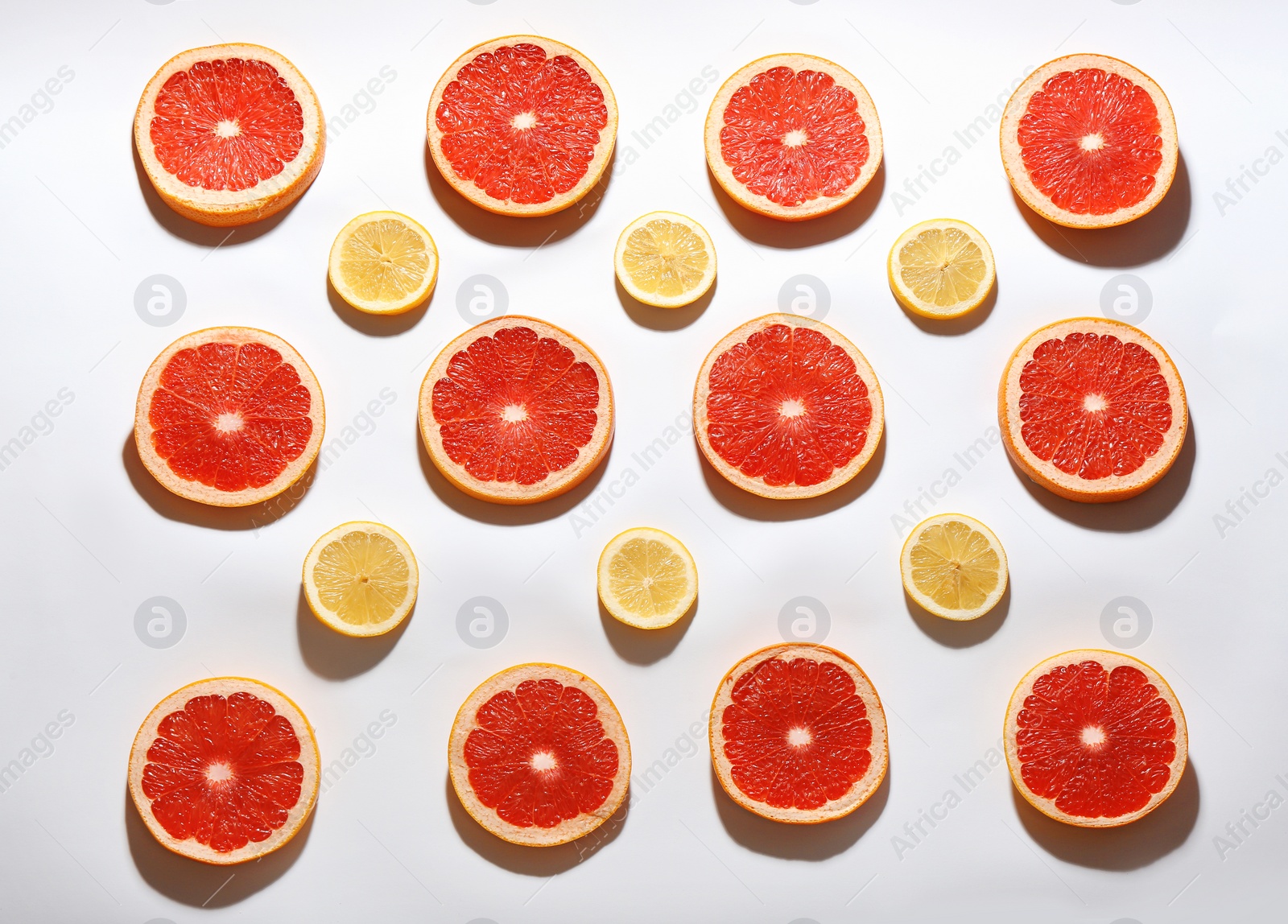 Photo of Flat lay composition with tasty ripe grapefruit slices on white background