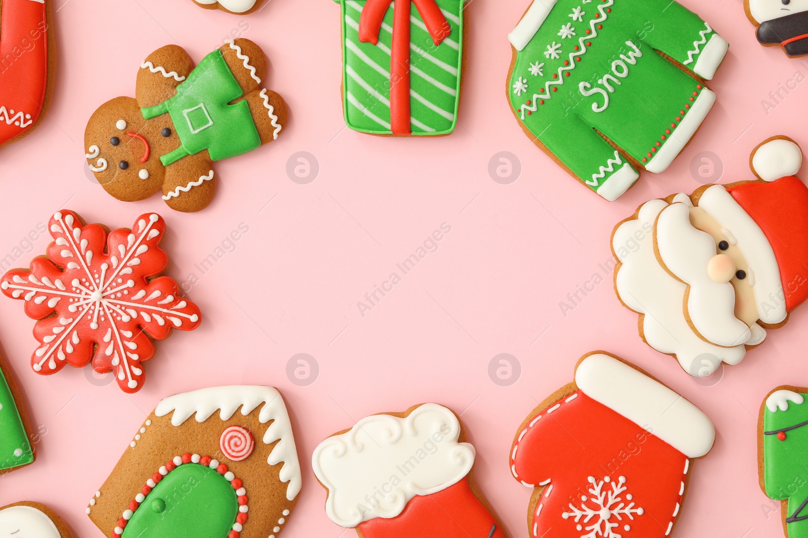 Photo of Different Christmas gingerbread cookies on pink background, flat lay. Space for text