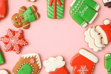 Photo of Different Christmas gingerbread cookies on pink background, flat lay. Space for text