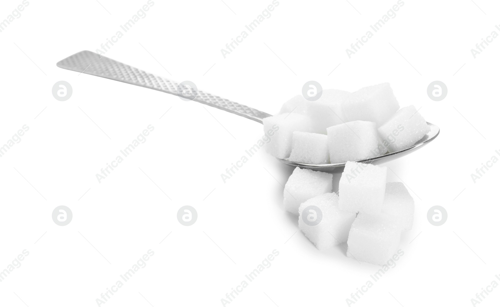 Photo of Sugar cubes and metal spoon isolated on white