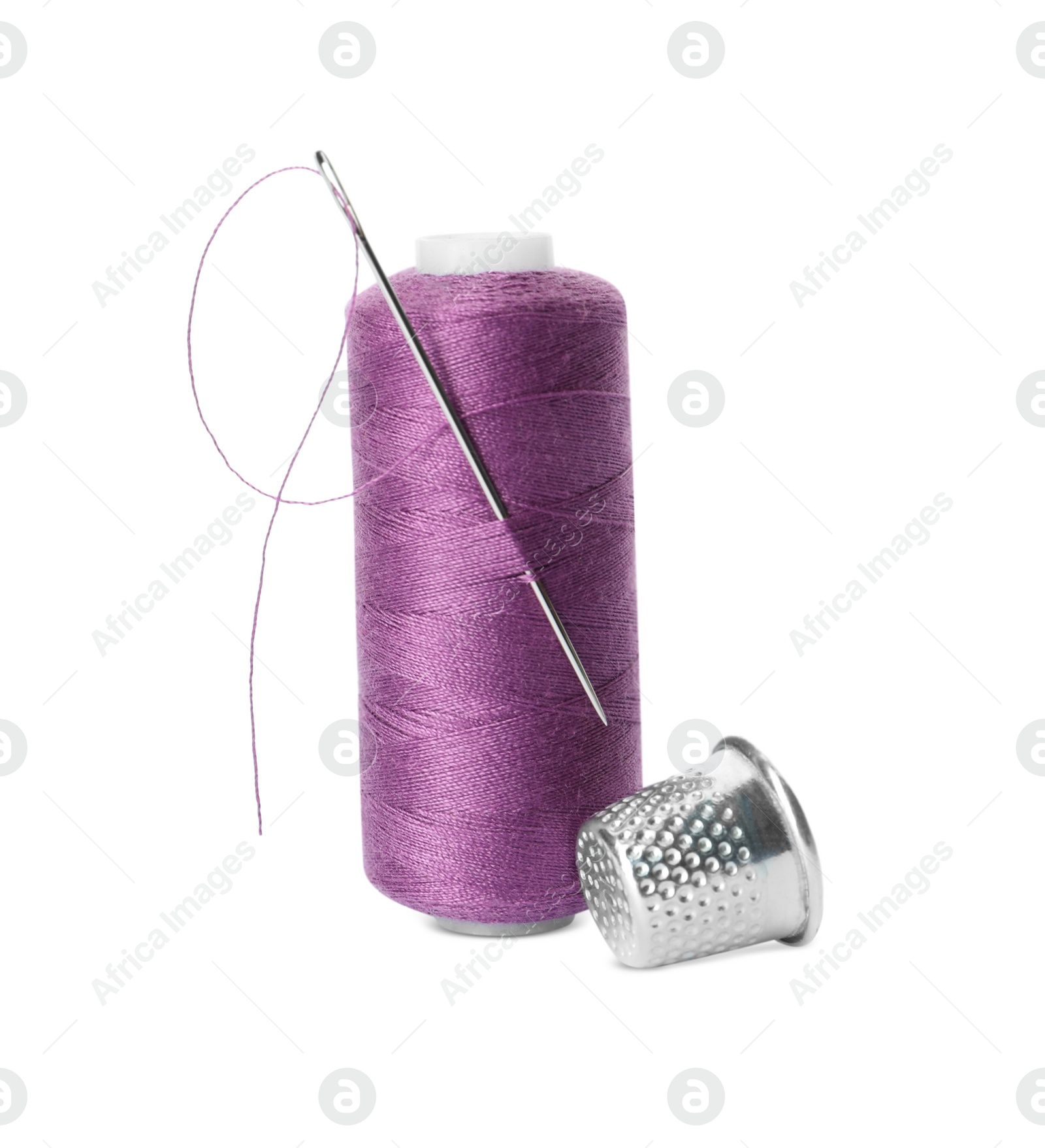 Photo of Spool of thread and sewing tools on white background