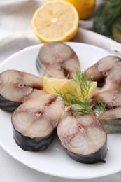 Photo of Slices of tasty salted mackerel, dill and lemon wedge on table, closeup