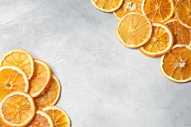 Photo of Dry orange slices on light grey table, flat lay. Space for text