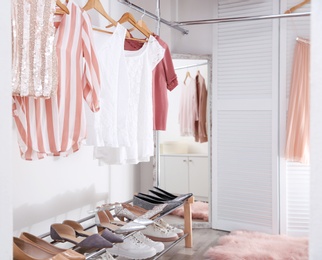 Modern dressing room with different stylish clothes and accessories