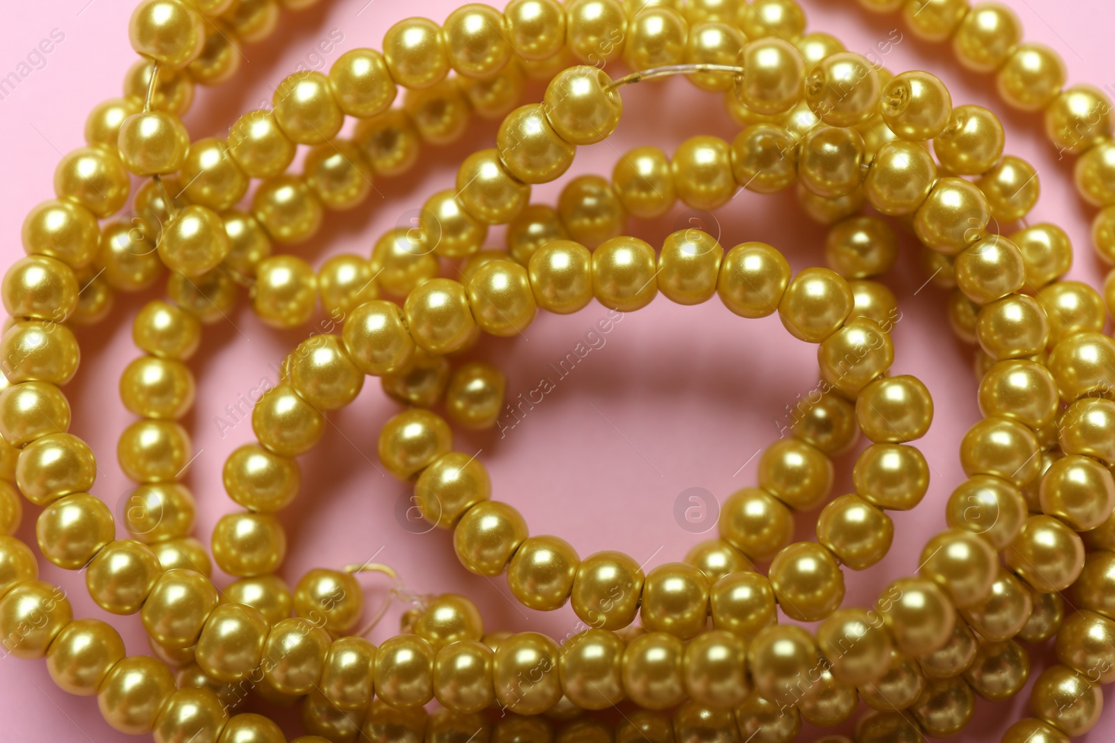 Photo of Beautiful handmade beaded necklace on pink background, closeup