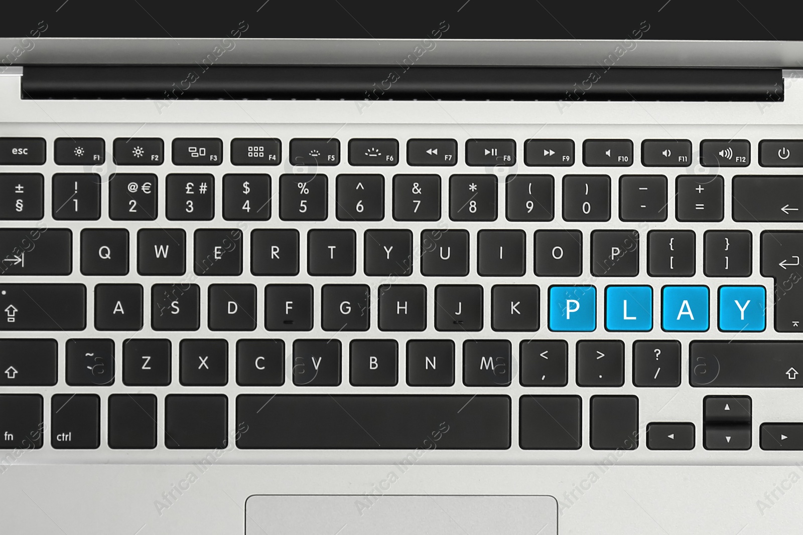 Image of Blue buttons with letters P L A Y on laptop keyboard, top view