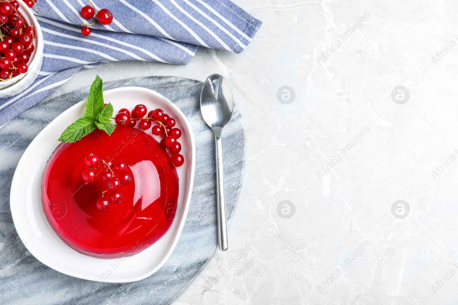 Photo of Delicious jelly with berries and mint on grey table, flat lay. Space for text