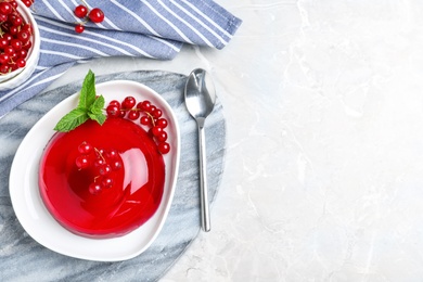 Delicious jelly with berries and mint on grey table, flat lay. Space for text