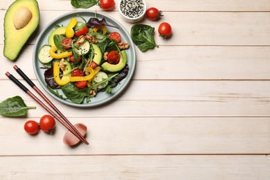 Balanced diet and vegetarian foods. Plate with different delicious products on wooden table, flat lay. Space for text