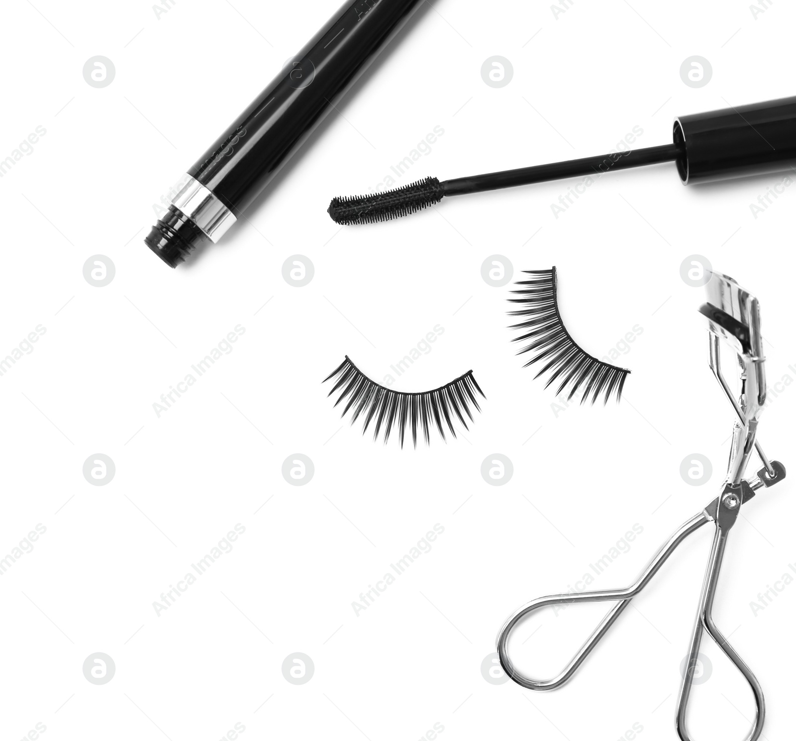 Photo of False eyelashes, mascara and curler on white background