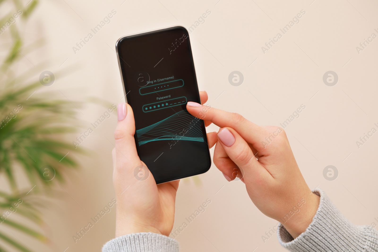 Photo of Woman unlocking smartphone with blocked screen indoors, closeup