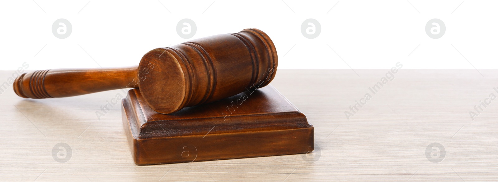 Photo of Wooden gavel on light table against white background. Space for text