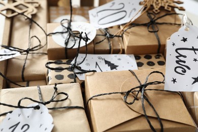 Photo of Set of gifts for Christmas advent calendar with tags, closeup