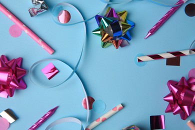 Photo of Different colorful festive decor on light blue background, flat lay