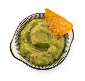 Photo of Bowl of delicious guacamole with nachos chip isolated on white, top view