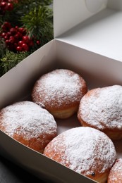 Delicious sweet buns in box on table, closeup