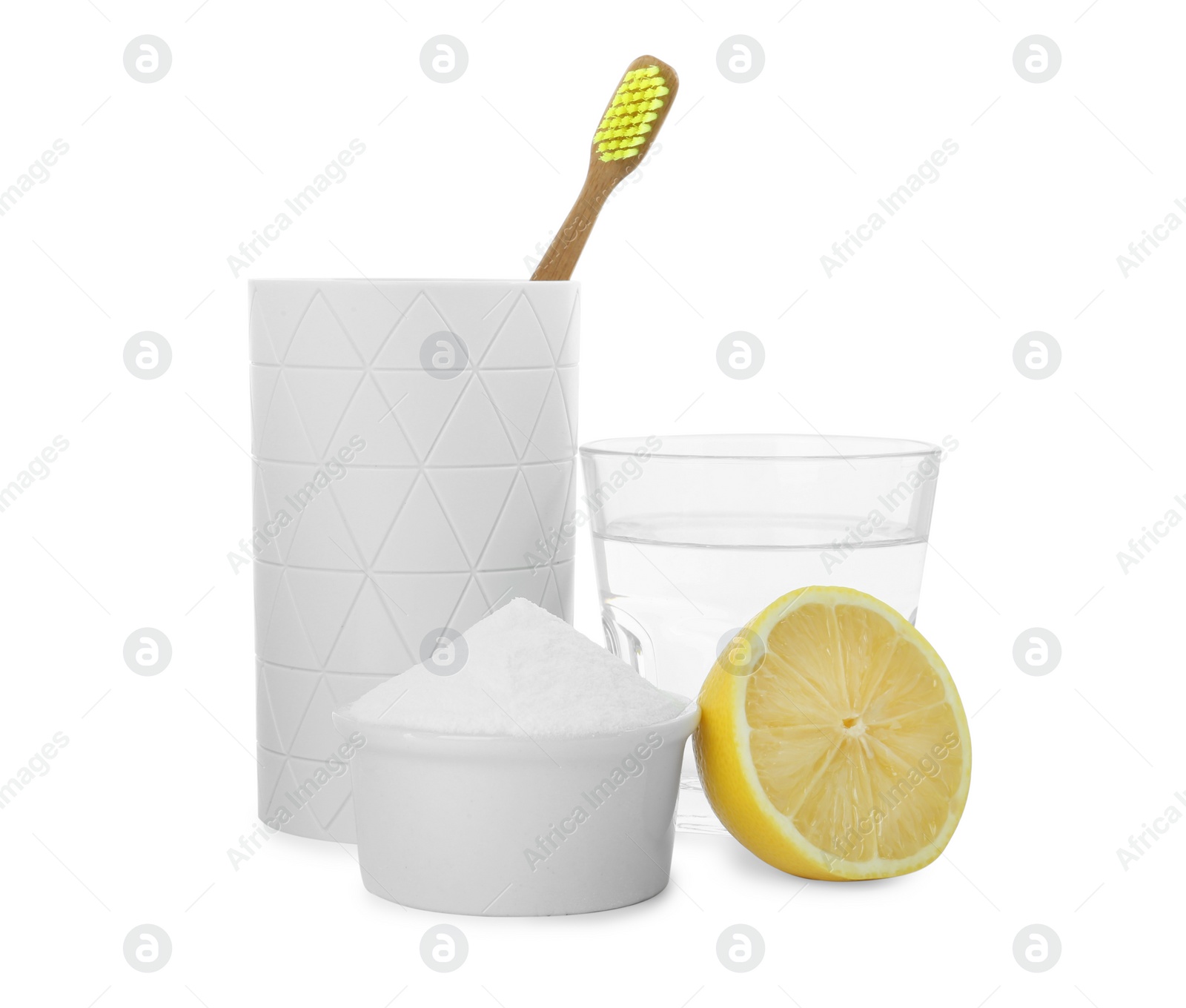 Photo of Bamboo toothbrush in holder, bowl with baking soda and fresh lemon on white background