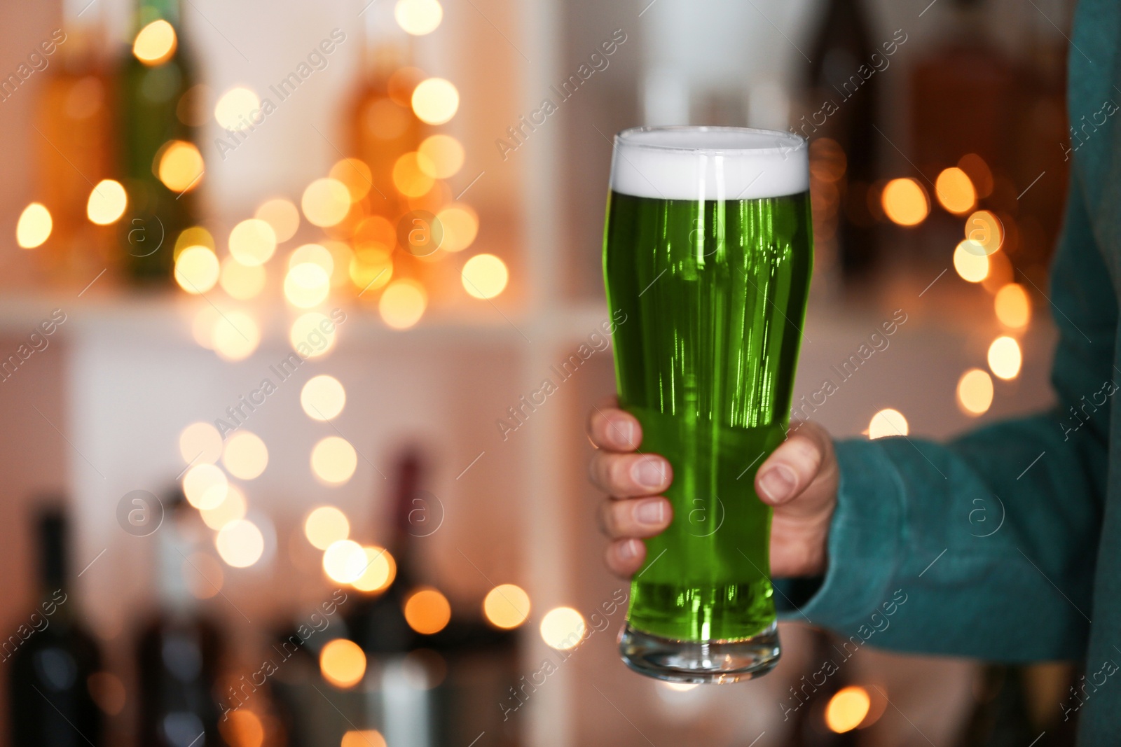 Photo of Closeup view of woman with green beer in pub, space for text. St.Patrick's Day celebration