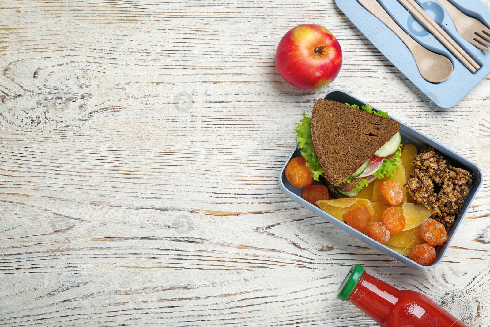 Photo of Flat lay composition with lunch box and appetizing food on wooden background