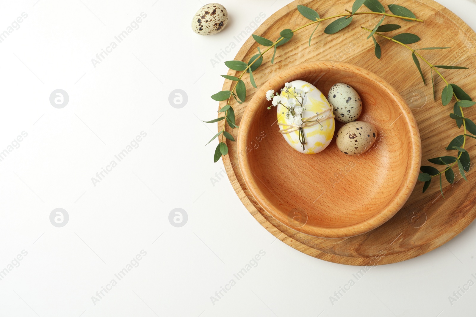Photo of Festive Easter table setting with eucalyptus and eggs, flat lay. Space for text