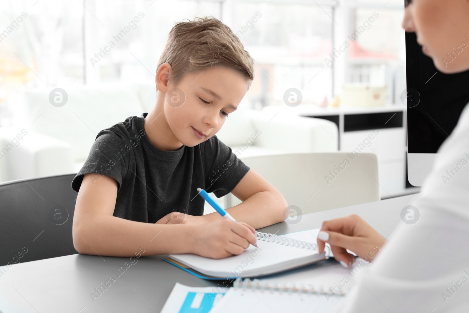 Photo of Little boy having appointment at child psychologist office