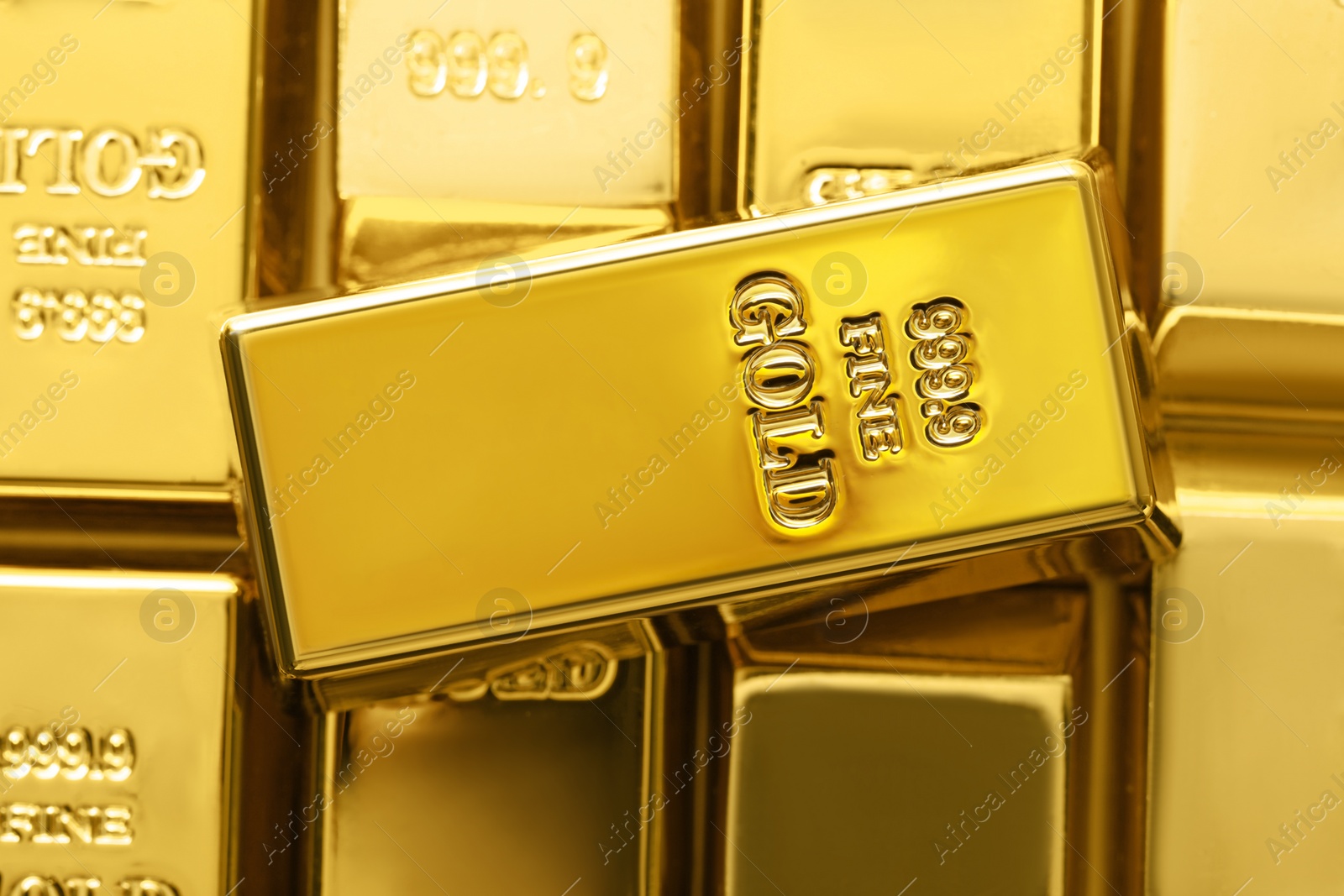 Photo of Many shiny gold bars as background, top view