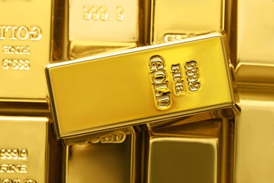 Many shiny gold bars as background, top view