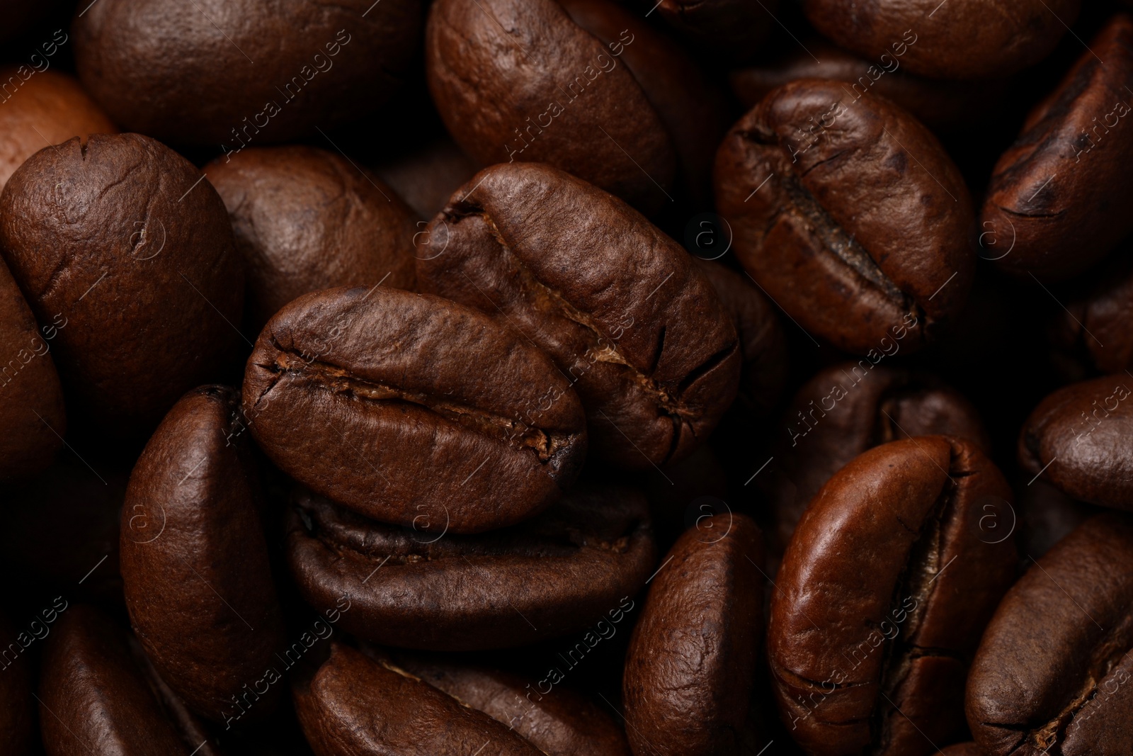 Photo of Aromatic roasted coffee beans as background, closeup